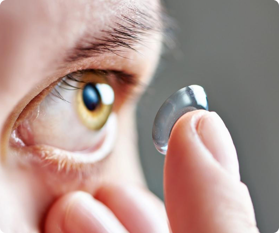 A person preparing to insert a contact lens